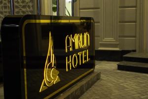 a sign for a hotel in front of a building at Reikartz Amirun Tashkent in Tashkent