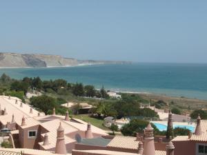 a view of a resort with a pool and the ocean at Belver Porto Dona Maria Resort in Luz