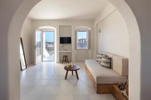 a living room with a couch and a table at Ammothines Cycladic Suites in Naxos Chora