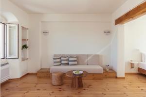 a bedroom with a bed and a table in a room at Ammothines Cycladic Suites in Naxos Chora