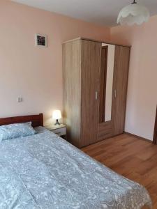 a bedroom with a large bed and a wooden cabinet at Boczna 9 Apartament in Karpacz