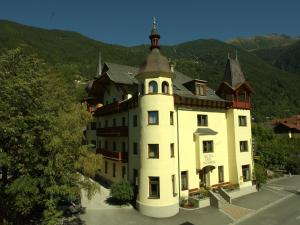 a large white building with a tower on top of it at Hotel 3 Mohren in Oetz