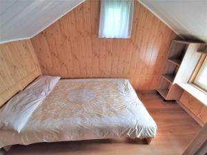 a small bedroom with a bed in a attic at Brzozowe Zacisze in Łagów