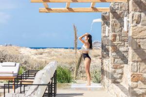 a woman standing in the doorway of a building at Ammothines Cycladic Suites in Naxos Chora