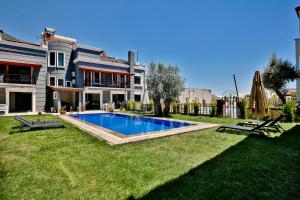 a house with a swimming pool in the yard at Nur Suites & Hotels in Kalkan