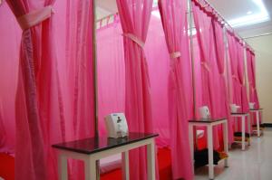 a row of pink curtains in a room at Classy Hotel in Battambang