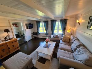 a living room with a couch and a table at Molandstveit in Osestad