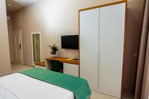 Postel nebo postele na pokoji v ubytování Toto Hotel & Apartments