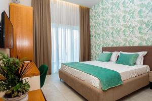 Postel nebo postele na pokoji v ubytování Toto Hotel & Apartments