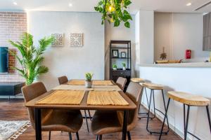 a dining room with a wooden table and chairs at Live here, enjoy waters of Arabian Gulf in Ras al Khaimah