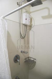 a shower in a bathroom with a shower curtain at Wind Residences Condotel in Tagaytay