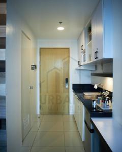 a kitchen with a door with a sink and a counter at Wind Residences Condotel in Tagaytay