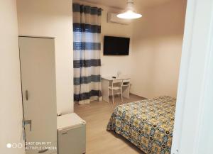 a bedroom with a bed and a table and a television at B&B Spirito Santo in Casal Sottano