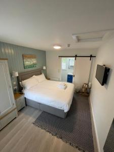 a bedroom with a white bed and a television at Belvedere House Cork Guest House in Cork