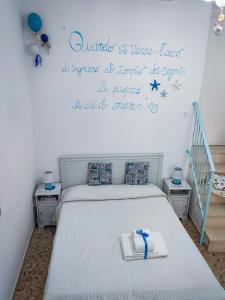 a bedroom with a bed with a book on it at La Casa Di Nicole in Polignano a Mare