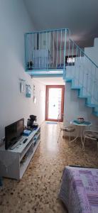 a living room with a blue staircase and a table at La Casa Di Nicole in Polignano a Mare