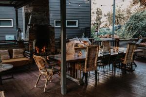 a patio with a table and a fireplace at Premalaya in Yallingup