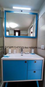 ポリニャーノ・ア・マーレにあるLa Casa Di Nicoleのバスルーム(青いシンク、鏡付)