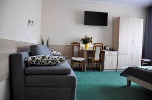 a living room with a couch and a dining room at Willa Sole in Busko-Zdrój