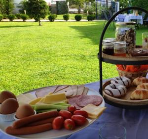 a plate of cheese and meats and vegetables on a table at Villa Riviera in Stavros