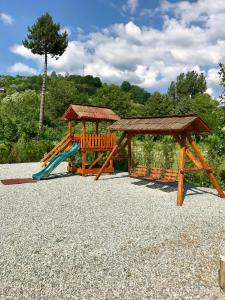 a playground with a slide and a gazebo at Casa Ralucăi in Moisei