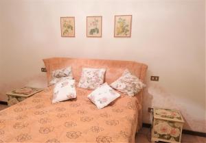 a bedroom with a bed with pillows on it at Casa Gisela in Desenzano del Garda