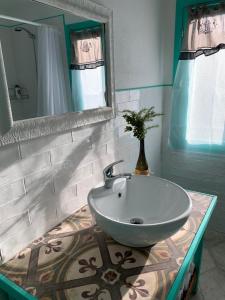 a bathroom with a sink and a mirror at Corte Boero Bed&Breakfast in Capoterra