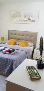 a bedroom with a bed and a table with a tray at Oleza Garden - Laguna Rosa - Playa Flamenca - Pool & Garden View. in Playa Flamenca +17 photos