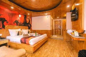 A bed or beds in a room at Hotel Smugglers Mountain View - central heated & air Cooled #Free Pick from Volvo Bus Stand