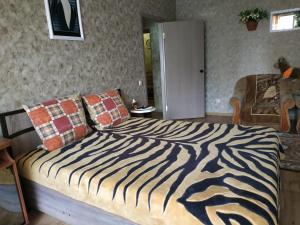 a bedroom with a bed with a zebra print blanket at Апартаменти в новому будинку біля Либідь Плаза-Квартал in Khmelʼnytsʼkyy