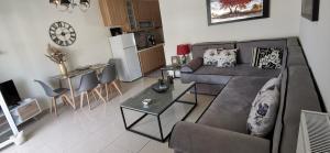 a living room with a couch and a table at Iris Deluxe Suites 2 in Kavála