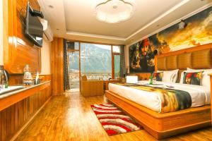 A bed or beds in a room at Hotel Smugglers Mountain View - central heated & air Cooled #Free Pick from Volvo Bus Stand