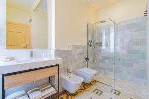 a bathroom with a sink and a toilet and a shower at Mosaiko Homes Catedral Granada in Granada