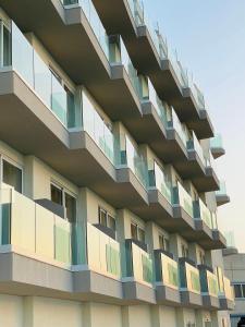 a building with balconies on the side of it at Hotel VIU57 in Mellieħa