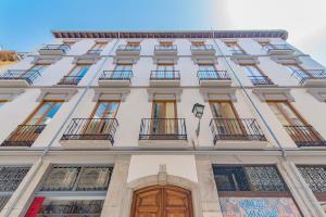 a facade of a building with windows and doors at Mosaiko Homes Catedral Granada in Granada