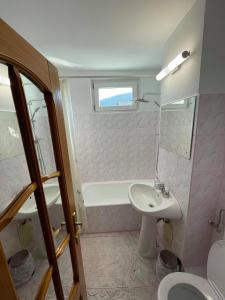 a bathroom with a sink and a toilet at Like Home - Cozy & Quite in Piatra Neamţ