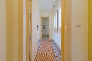 an empty hallway with a tile floor in a hallway at Mosaiko Homes Catedral Granada in Granada