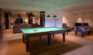 a living room with a pool table and a couch at Galway Heights Hotel in Nuwara Eliya