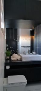 a bathroom with a sink and a toilet at CUBE apartments in Vir +59 photos