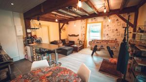 a large living room with a table and a couch at GITE COEUR DE NATURE in Abergement-le-Grand