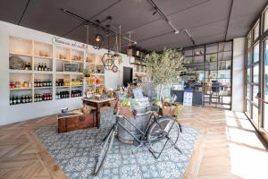 a store with a bike in the middle of a room at Lago Idro Glamping Boutique in Anfo