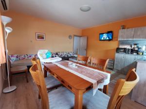 a kitchen and dining room with a table and chairs at Rose valley guest house in Kazanlŭk