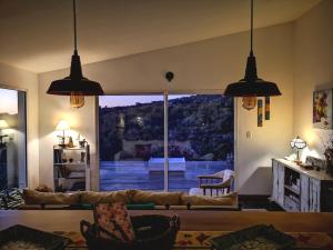a living room with a large window with a view at GUIDAI in Villa Serrana