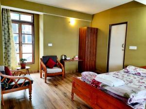 Postel nebo postele na pokoji v ubytování Kalimpong Sunrise-Inn Homestay