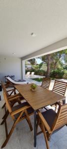 a dining room with a wooden table and chairs at CUBE apartments in Vir