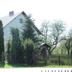 a white house with a fence in front of it at Siedlisko Pauza in Kozłów