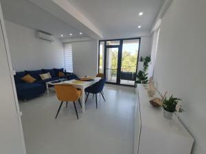 a living room with a table and a blue couch at Sea view Oxygen Neptun in Neptun