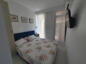 a bedroom with a bed and a window at Sea view Oxygen Neptun in Neptun
