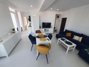 a living room with a blue couch and a table at Sea view Oxygen Neptun in Neptun