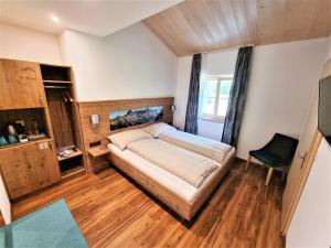 a bedroom with a bed and a chair in it at Triftblick in Gadmen